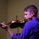 Male violinist of Ruscica Music performing at the Jessup lecture hall