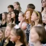Ruscica Music choir singing at the Jessup lecture hall